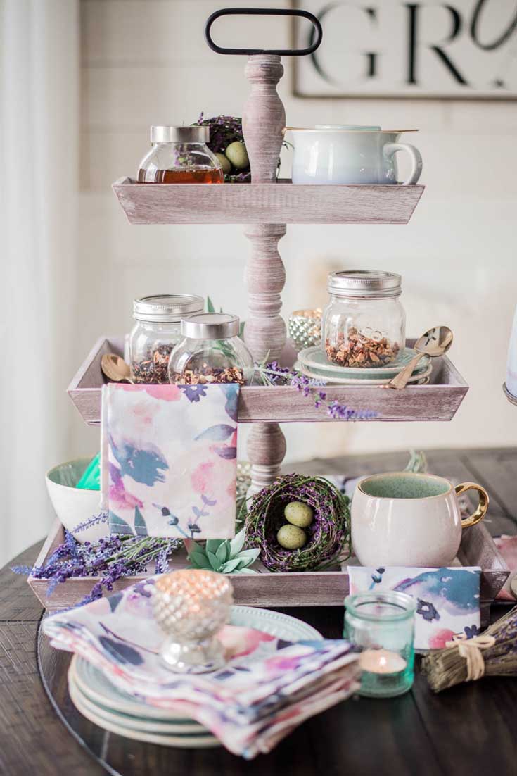 Create a tea station out of a cake stand. Cake stands are easy ways to decorate a table or your home. I have gathered some Cute Ways to Use a Cake Stand that I'm sure you'll love. You can use them for the holidays or even a wedding reception. They add drama and interest because of their styles and heights. #cakestands #decorating #weddings #flowers #decor