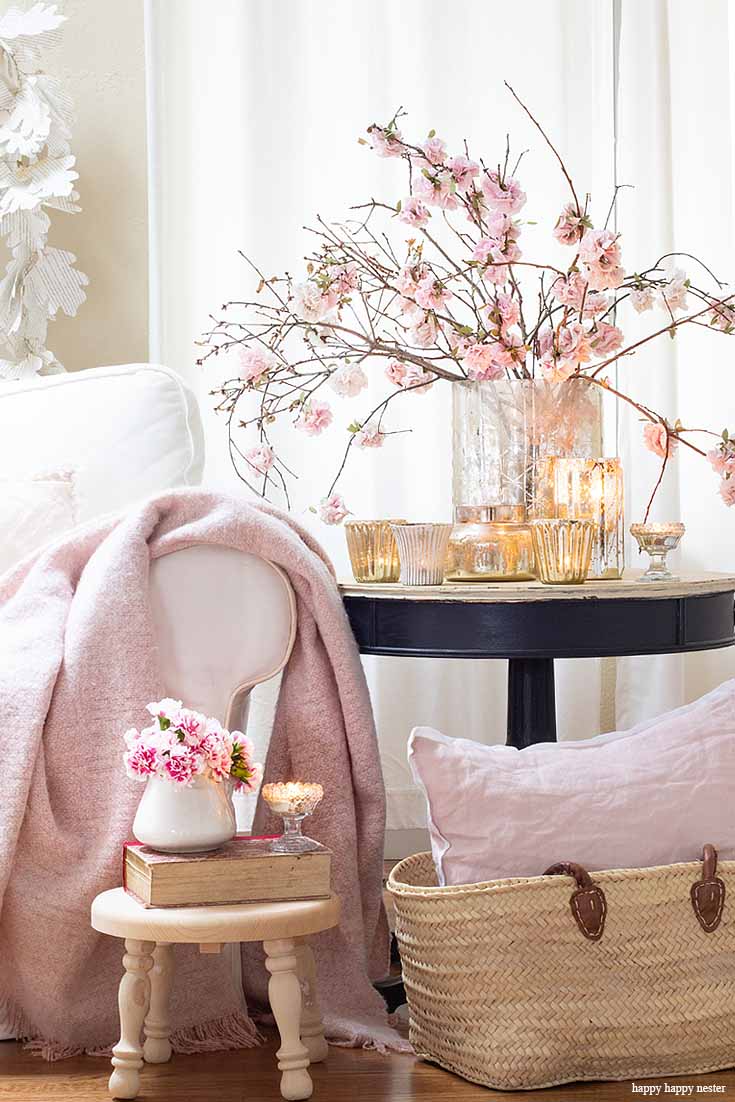 Add candles and paper flowers to create a new spring home. The best way to say goodbye to winter is a Pretty Pink Spring Home Tour. I love how happy the color pink is, and it is so pretty in our living room, entry and dining room. Adding fresh flowers brightens a home and welcomes family and friends with a warm embrace. #decorating #springdecor #springtour #pinkdecor #hometour