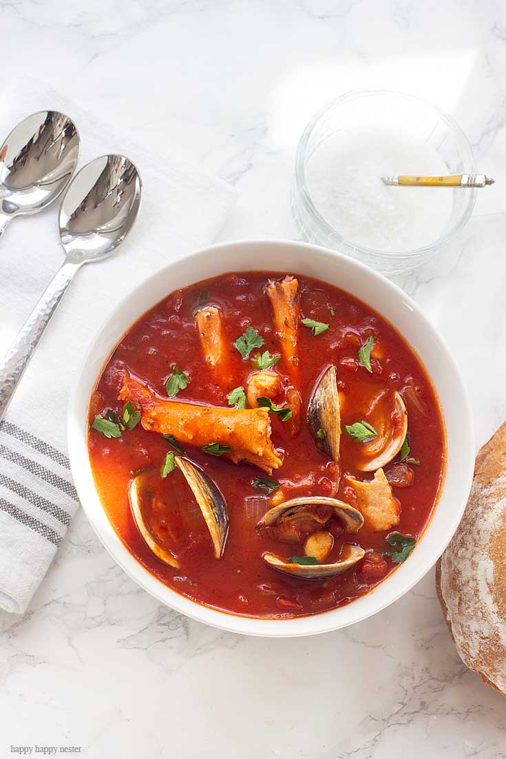 Our family favorite Yummy Seafood Stew Recipe is the best San Francisco style Cioppino. Make this the evening before so all the flavors are their best. This is the best Cioppino recipe since it includes wine and sugar to balance and mellow the acid from the tomatoes. #cioppino #italiandinner #soup #fishstew