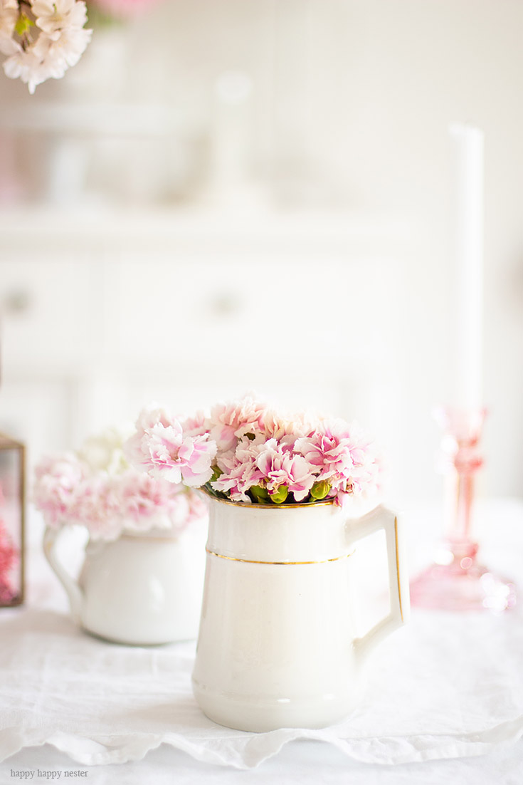 Find creative ways to add flowers to your spring home. The best way to say goodbye to winter is a Pretty Pink Spring Home Tour. I love how happy the color pink is, and it is so pretty in our living room, entry and dining room. Adding fresh flowers brightens a home and welcomes family and friends with a warm embrace. #decorating #springdecor #springtour #pinkdecor #hometour