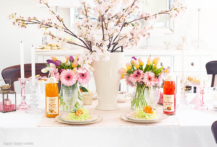 A Spring Table is Always Great for Easter. Need some help with your Spring Floral Arrangements? I came up with an easy and pretty bouquet using simple tulips and daises. It takes a few minutes to make and your home is bursting with spring happiness. You don't have to spend much time and money on your flowers. #flowers #springflowers #floralarrangements #tulips