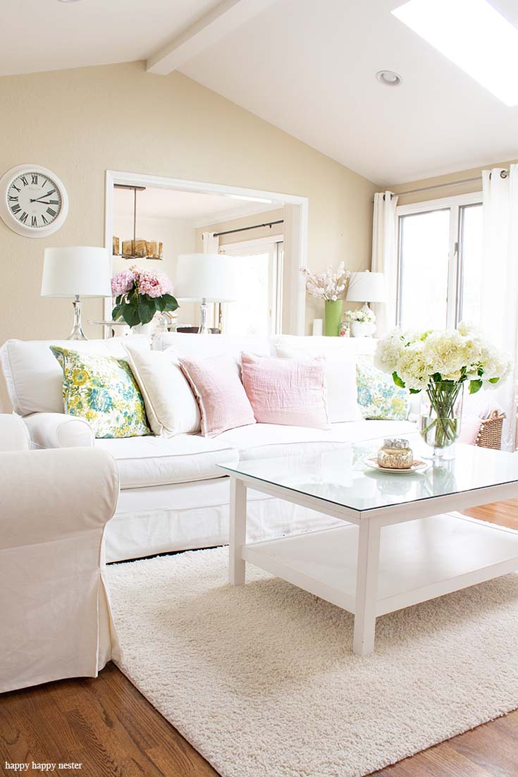 Learn how I add fresh pink hydrangeas with spring pillows to create a spring style. The best way to say goodbye to winter is a Pretty Pink Spring Home Tour. I love how happy the color pink is, and it is so pretty in our living room, entry and dining room. Adding fresh flowers brightens a home and welcomes family and friends with a warm embrace. #decorating #springdecor #springtour #pinkdecor #hometour
