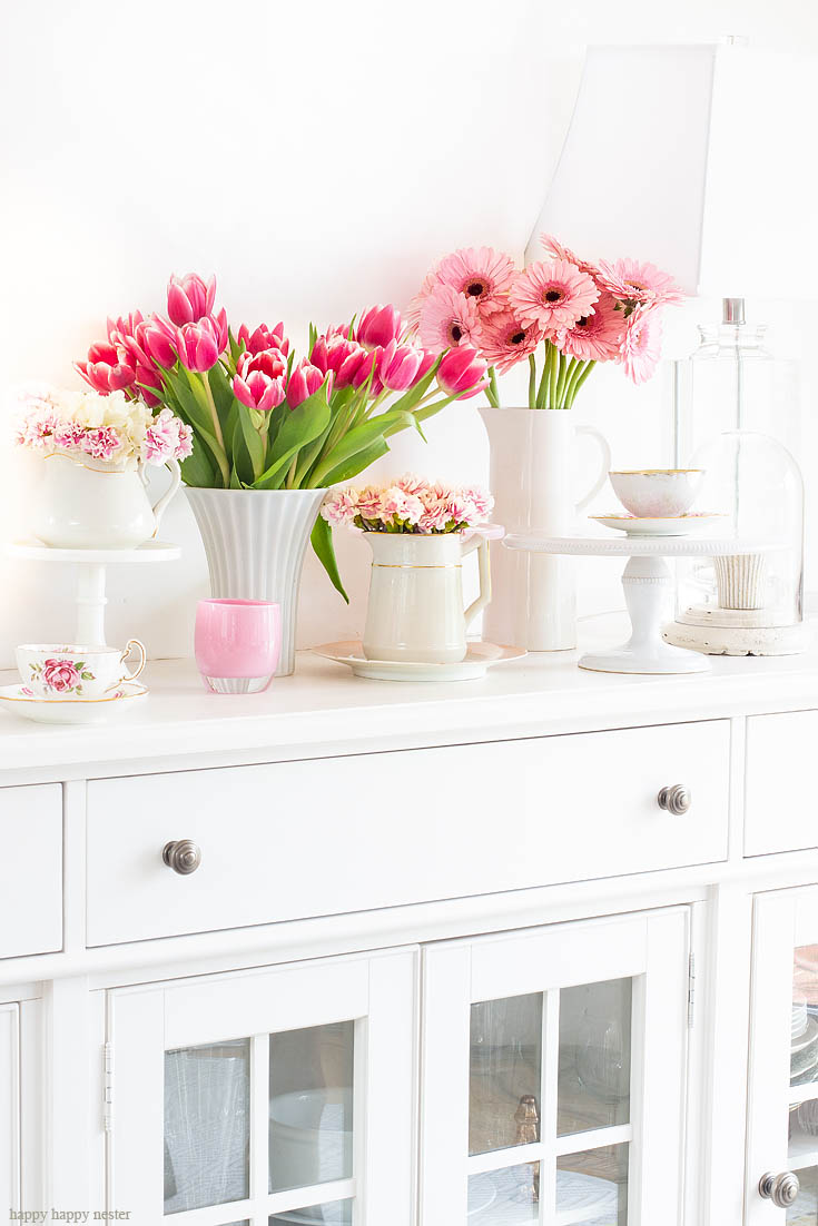 Tour our cottage home from room to room this spring. The best way to say goodbye to winter is a Pretty Pink Spring Home Tour. I love how happy the color pink is, and it is so pretty in our living room, entry and dining room. Adding fresh flowers brightens a home and welcomes family and friends with a warm embrace. #decorating #springdecor #springtour #pinkdecor #hometour