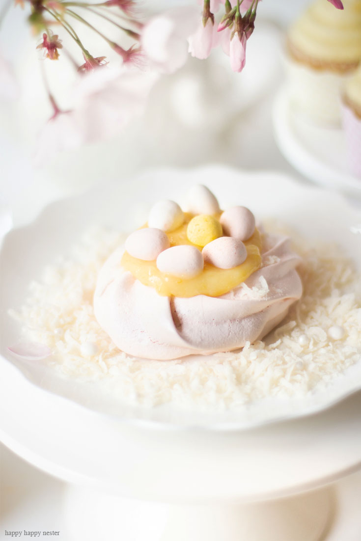 Cute Easter Desserts. This Pavlova Recipe is so easy and the Mini Nests are so adorable. They are perfect for Easter, a spring dessert or year-round treat. Use different food colors to create cute fresh nests. Top the nests with lemon curd, whip cream, and Easter eggs. #baking #easter #desserts #easterdesserts #meringue #pavlova #lemoncurd