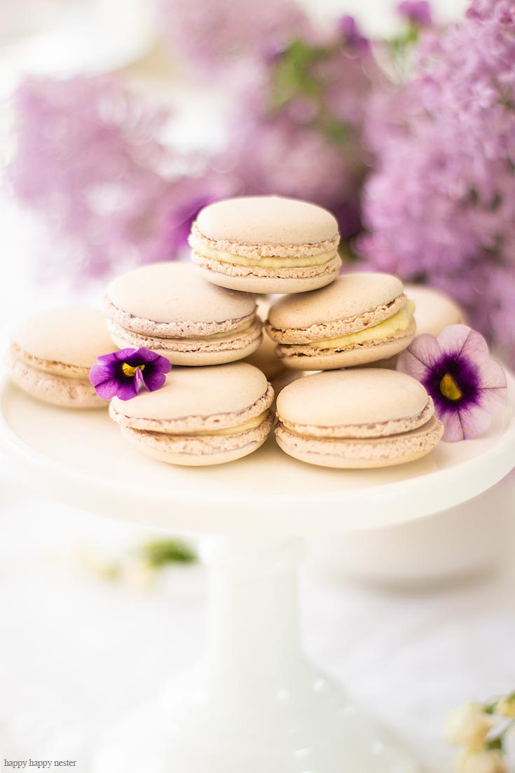 These yummy french macaron cookies are just a few items on this beautiful spring table. It doesn't take much to create a Beautiful Spring Table with Fresh Flowers. This spring table with fresh lilacs and other garden flowers is so easy to create. No need to spend much to style a fabulous spring table. #springtable #flowerbouquet #freshflowers #lilacs #lavendertable #decoratingwithlilacs #purplelilacs