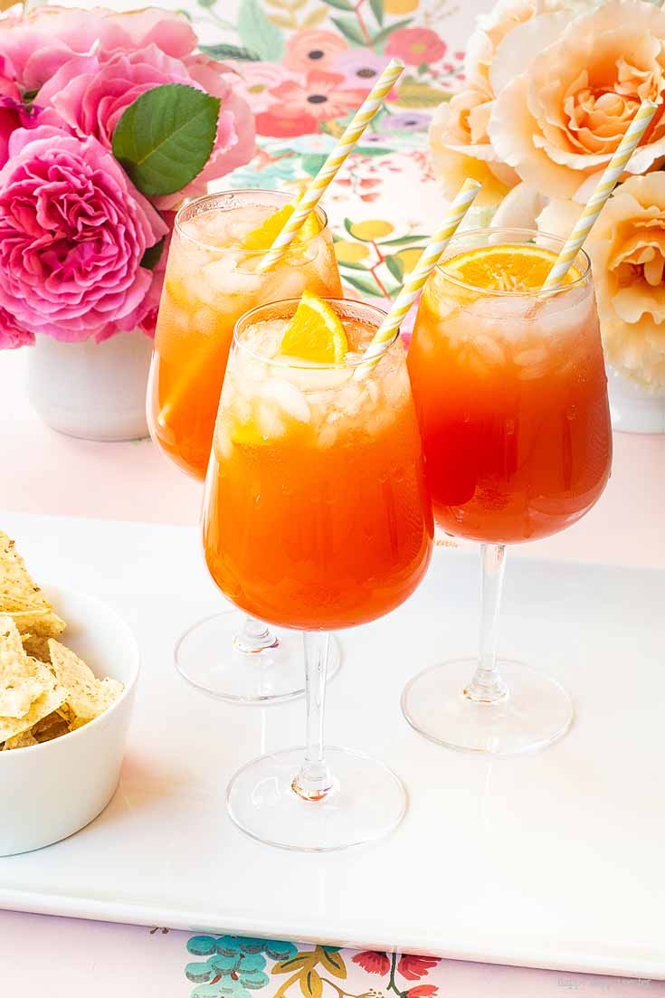This Simple Punch Recipe for Mother's Day. Make this easy drink for special occasions or any party. Make it with rum or as a non-alcoholic drink. This Planters Punch drink has pineapple, orange juice, and grenadine in the ingredients. #drinks #cocktails #punch #weddings #weddingparty #rum #planterpunch #mocktails