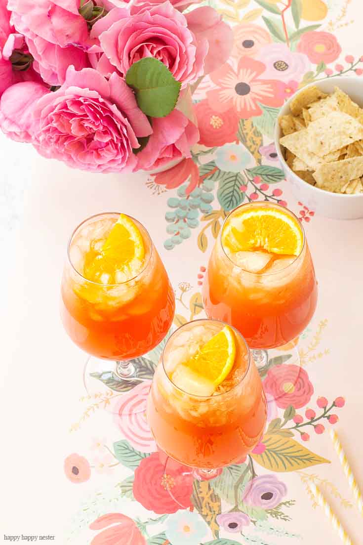 This Simple Punch Recipe for Mother's Day. Make this easy drink for special occasions or any party. Make it with rum or as a non-alcoholic drink. This Planters Punch drink has pineapple, orange juice, and grenadine in the ingredients. #drinks #cocktails #punch #weddings #weddingparty #rum #planterpunch #mocktails