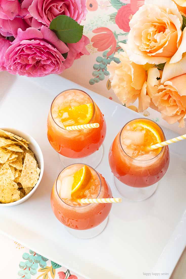 Enjoy this wonderful drink. This Simple Punch Recipe for Mother's Day. Make this easy drink for special occasions or any party. Make it with rum or as a non-alcoholic drink. This Planters Punch drink has pineapple, orange juice, and grenadine in the ingredients. #drinks #cocktails #punch #weddings #weddingparty #rum #planterpunch #mocktails