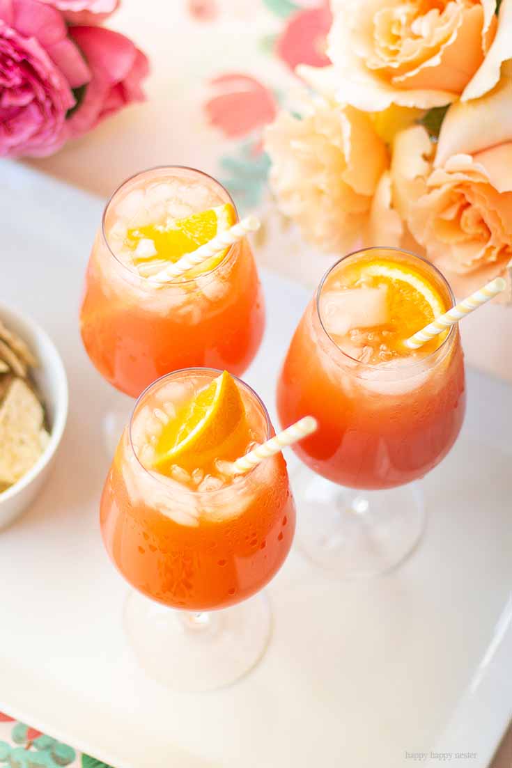 Love this yummy cocktail. This Simple Punch Recipe for Mother's Day. Make this easy drink for special occasions or any party. Make it with rum or as a non-alcoholic drink. This Planters Punch drink has pineapple, orange juice, and grenadine in the ingredients. #drinks #cocktails #punch #weddings #weddingparty #rum #planterpunch #mocktails
