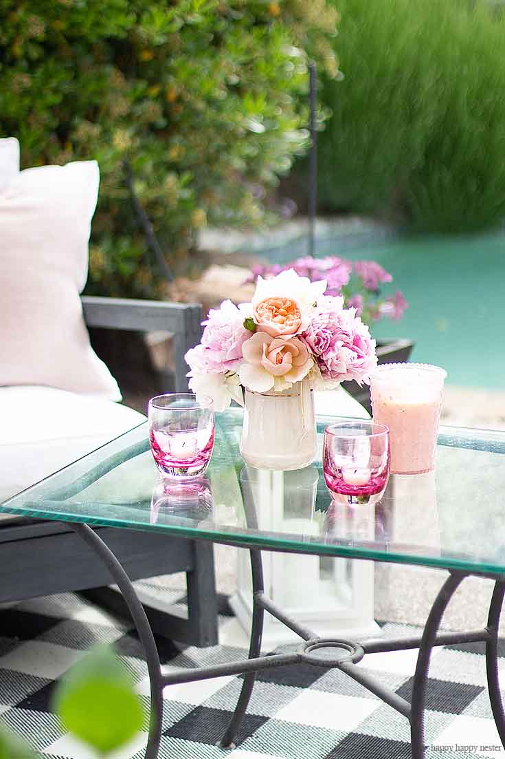 Enjoy your gardens flowers and display them when entertaining for the summer. And learn Learn How to Create a Cozy Outdoor Living Space in 9 easy tips. This DIY to summer decorating is essential. #summerdecor #outdoorlivingspaces #entertaining