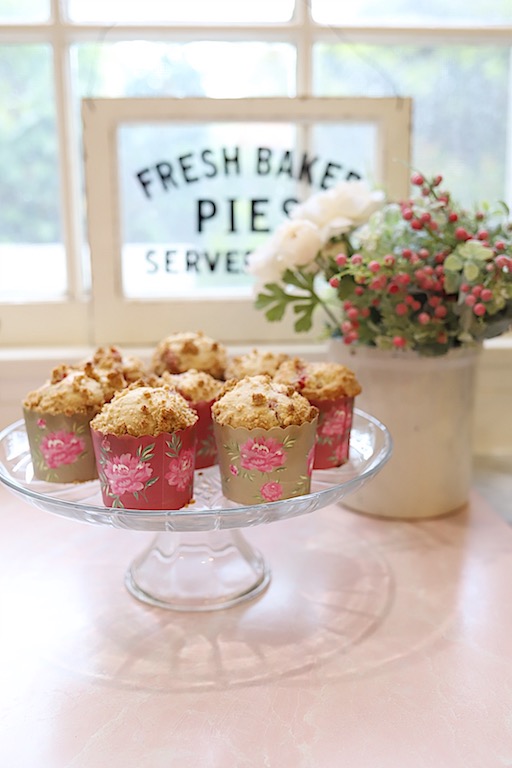 Strawberry muffins on a cake stand.