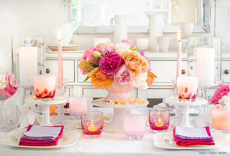 a full length table setting with flowers and candles