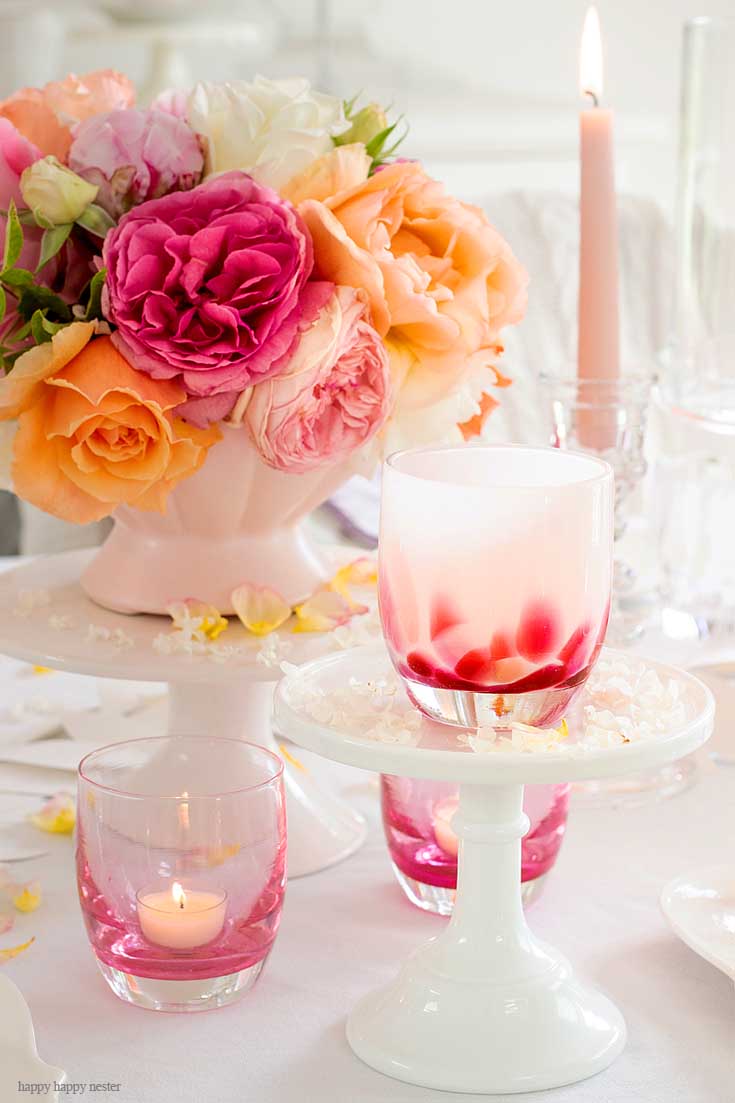 Roses on a white table with candles