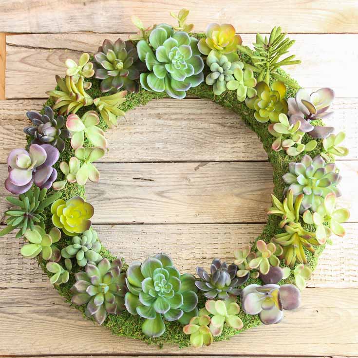 This beautiful summer wreath is a faux succulent that looks so realistic. Learn how The Happy Housie created this awesome wreath! #summer #wreaths #diy