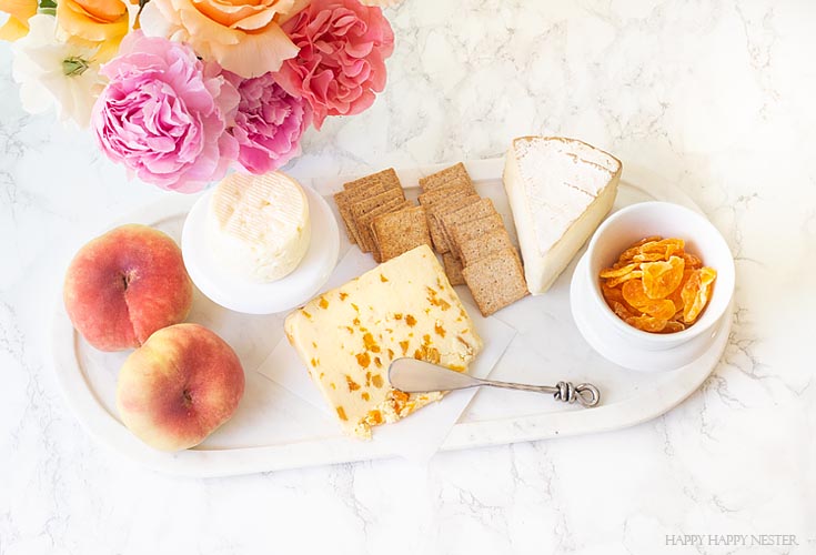 Learn how to create this cheese charcuterie cheese board. It only takes a few minutes, and yet it is a delicious combination of fruit and cheeses. #appetizers #parties #entertaining #charcuterieboards #charcuterie #recipes