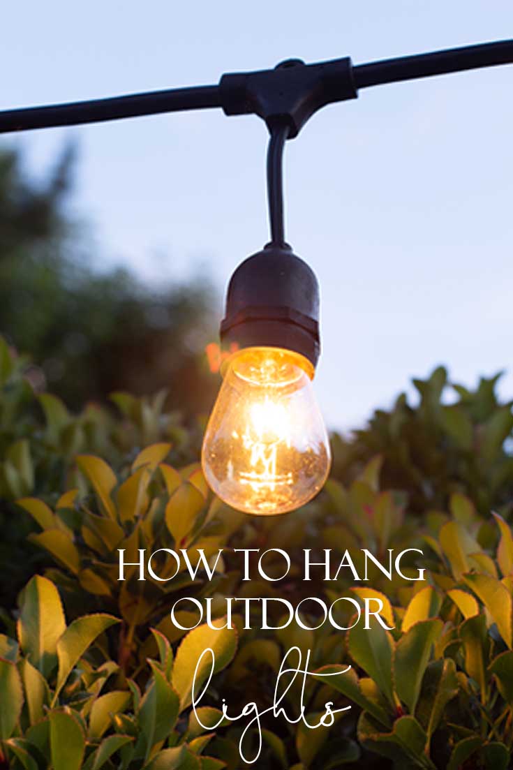 This tutorial shows How to Hang Outdoor String Lights for your summer patio. Learn how with step by step instructions on how to install a wooden post into cement. #diy #homeimprovement #outdoorlights #summerproject