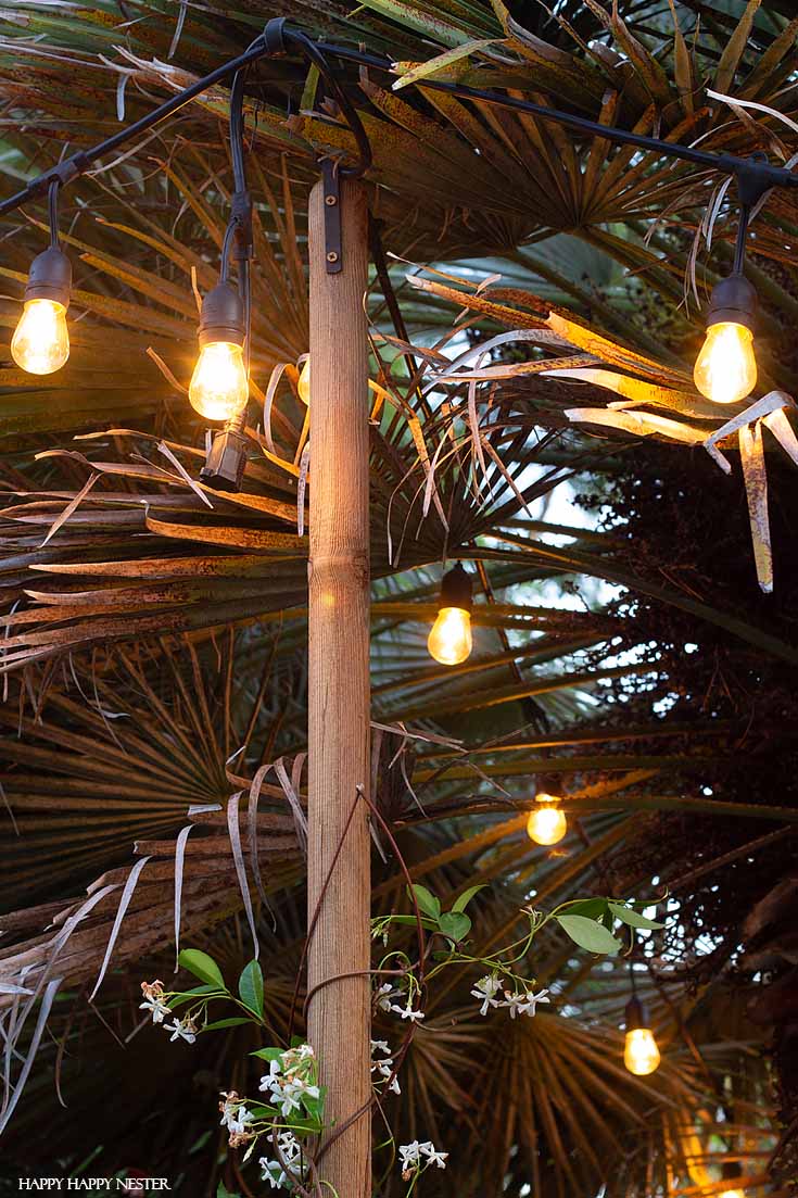 Learn how to Hang Outdoor String LIghts in cement supports in this very thorough tutorial. This technique and DIY is a solid solution. Also, the light poles are easy to install and are quite stable. #DIY #outdoorlights #patios #gardenprojects