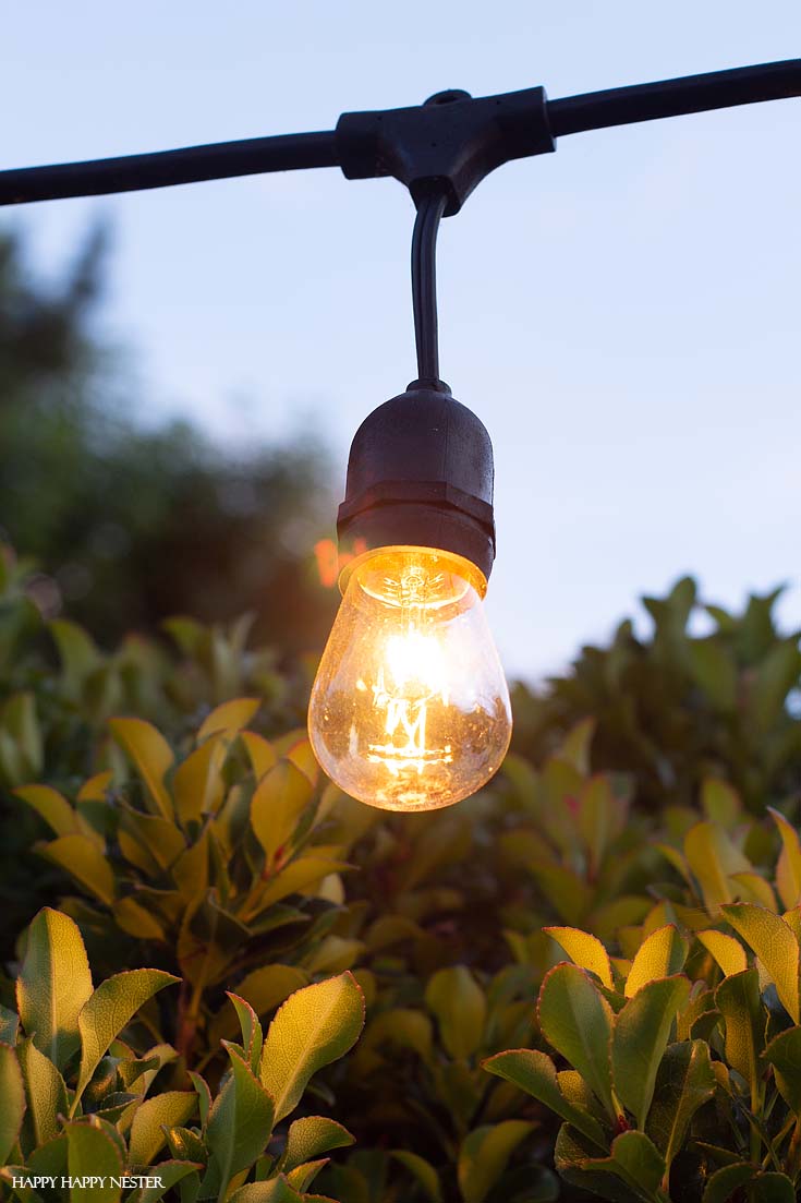 Learn how to Hang Outdoor String LIghts in cement supports. This technique is a solid solution and these light poles are easy to install and are stable.#DIY #outdoorlights #patios #gardenprojects