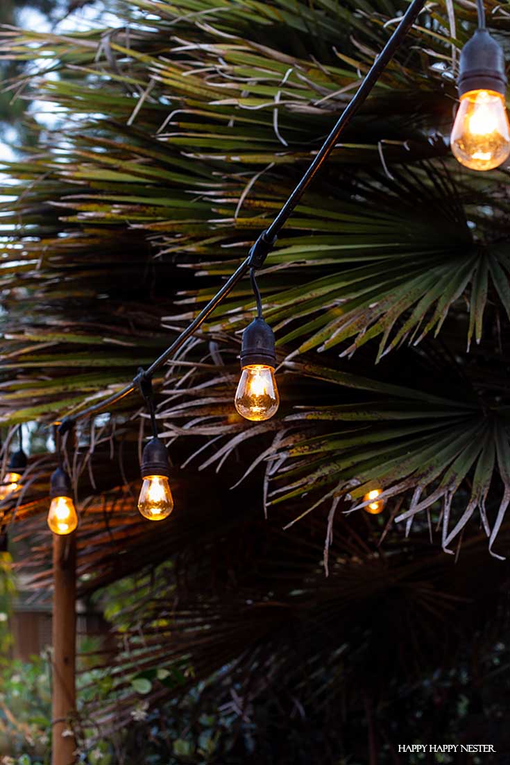 Learn the tricks on how to Hang Outdoor String LIghts in cement supports. This technique and DIY is a solid solution. Also, the light poles are easy to install and are quite stable. #DIY #outdoorlights #patios #gardenprojects
