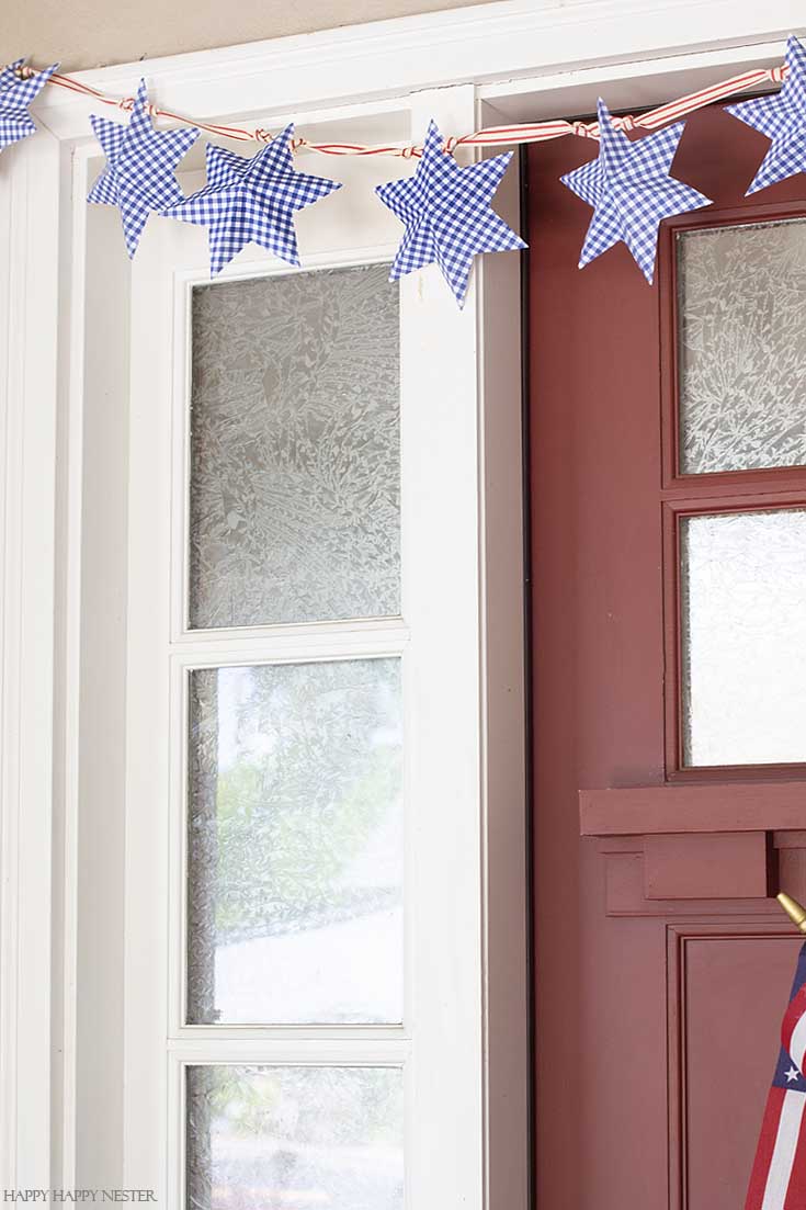 Create this 4th of July Star Garland out of paper and a free printable. Add a cute ribbon and hang it on your door or wall. Easy to follow video tutorial shows how to make this pretty star garland. #paperproject #diy #garland #papercrafts #crafts #4thofJulyproject #homedecor