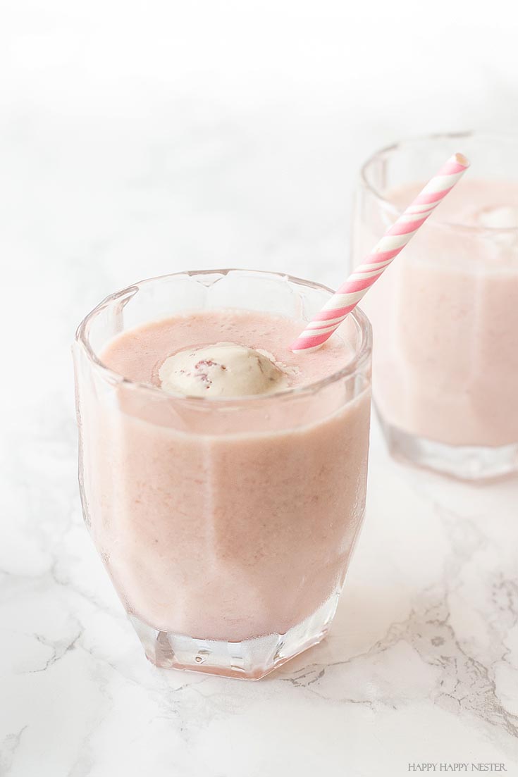 Yummy pink drink for summer entertaining. Get this delicious recipe that includes, coconut juice, strawberry ice cream, strawberries, bananas, and ginger ale. This is a blend between a smoothie and an old-fashion punch. #summer #drinks, #recipes, #drinkrecipes, #cocktails