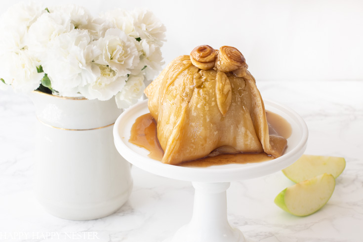 Need a delicious apple dessert but don't want to put a lot of effort into it? Then you need to try this Easy Apple Dessert. The apple is stuffed with sugared nuts inside the core and topped with a pastry dough covered in a yummy caramel sauce. Use the ready-made pie crust to make this an easy and quick dessert. #dessert #appledumpling #appledesserts