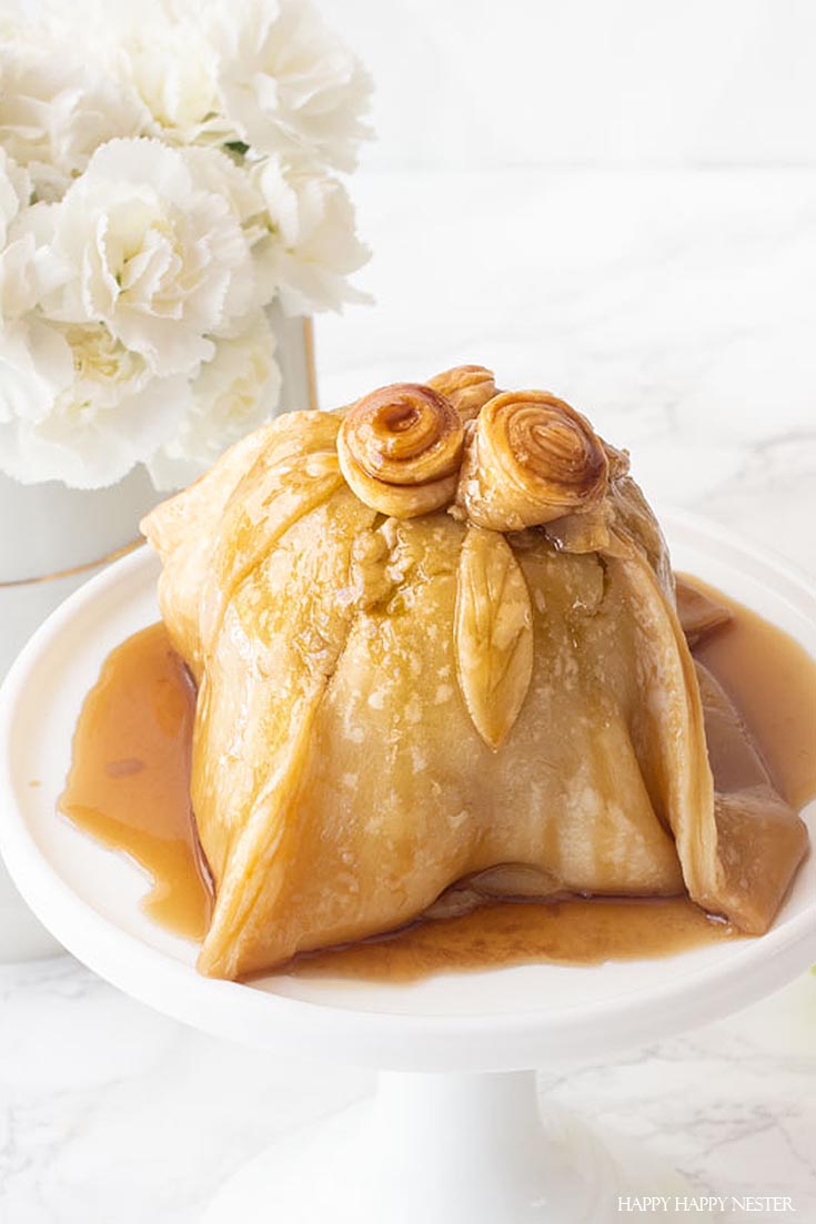 This Easy Old Fashioned Apple Dumpling Dessert is so delicious. The apple is stuffed with sugared nuts inside the core and is topped with a pastry dough covered in a yummy caramel sauce. Use the ready-made pie crust to make this an easy and quick dessert. #dessert #appledumpling #appledesserts