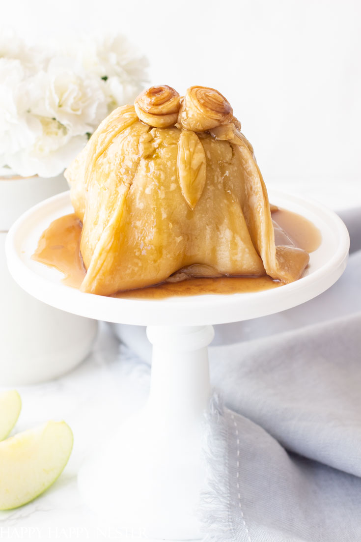 This Easy Apple Dumpling Dessert with Caramel Sauce is so delicious. The apple has sugared nuts inside the core and is topped with a pastry dough covered in a yummy caramel sauce. #dessert #appledumpling #appledesserts