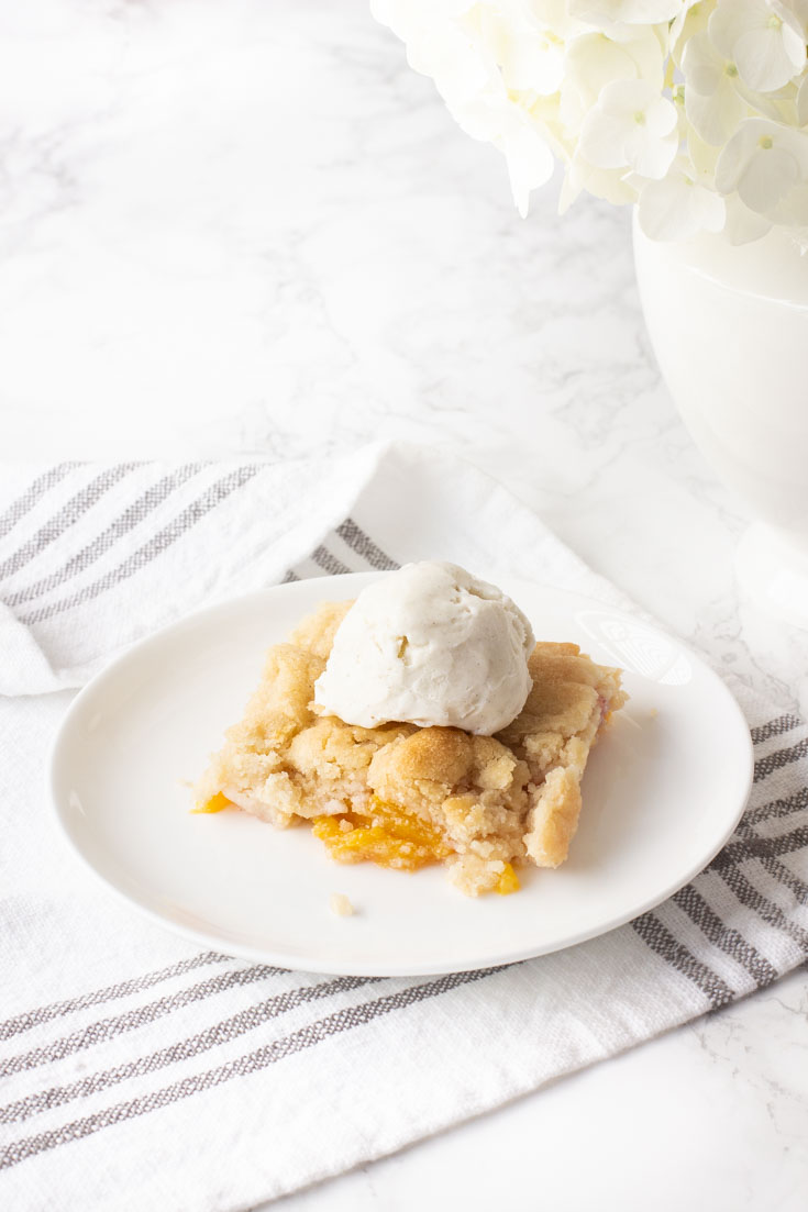 This Peach Cobbler with Almond Cookie Dough is a delightful and subtle blend of almond and peaches. It is a new twist to a summer dessert of fresh fruit. #peachcobbler #recipe #desserts #freshfruitrecipe