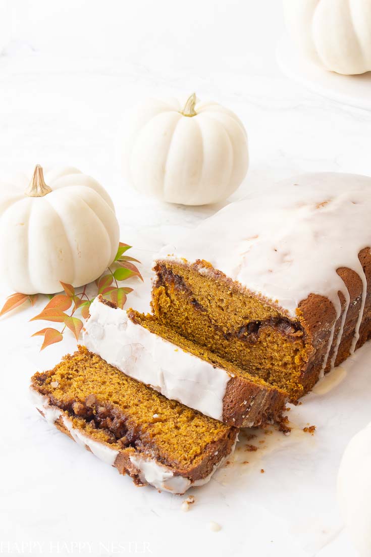 This Moist Pumpkin Bread Recipe has a cinnamon, sugar and nut swirl in the middle and topped with icing. Also, this pumpkin bread is easy to make and yummy.