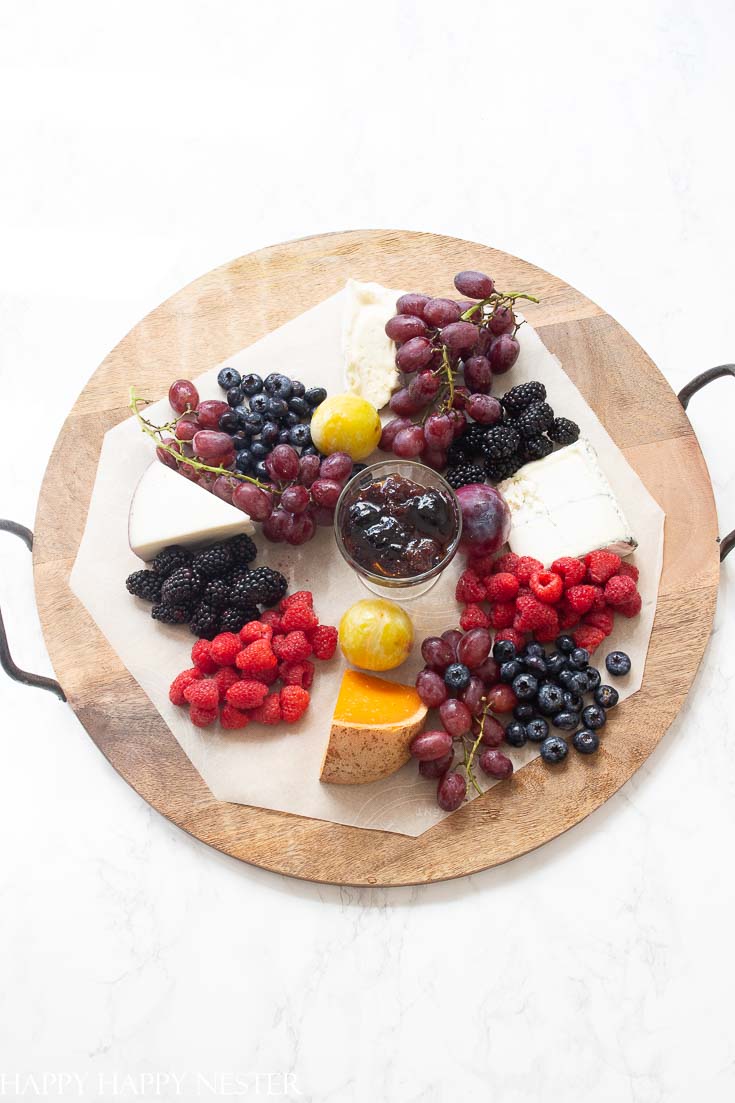 Need some Easy Appetizer Ideas for a Party, then you'll want to view this step by step tutorial. It shows how to build a fruit, cheese charcuterie board. These amazing boards with delicious gourmet foods will impress your guests! Get started on this great appetizer and you'll create a ton of wonderful party foods. #appetizers #easyappetizers #charcuterieboard