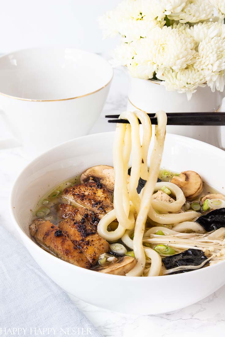 This Chicken Soup dish uses thick Japanese Udon Noodles that make this broth utter perfection. Find the tasty thick udon noodles at your Asian grocery store. Learn how to make this wonderful comfort food recipe. #chickennoodlesoup #soup #udon #japanesecuisine