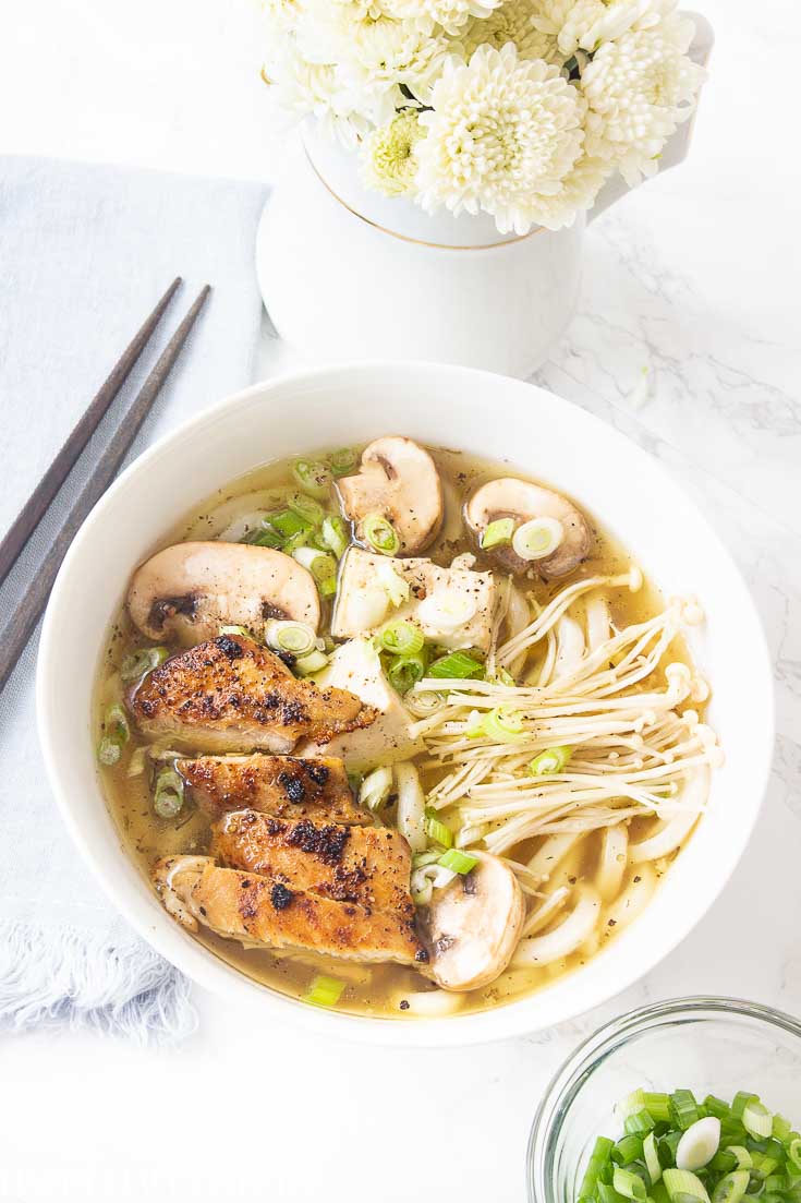 This Homemade Chicken Noodle Soup goes beyond the traditional recipe. It uses the delicious Japanese Udon Noodles that make this broth utter perfection. Find the tasty thick udon noodles at your Asian grocery store. #chickennoodlesoup #soup #udon #japanesecuisine