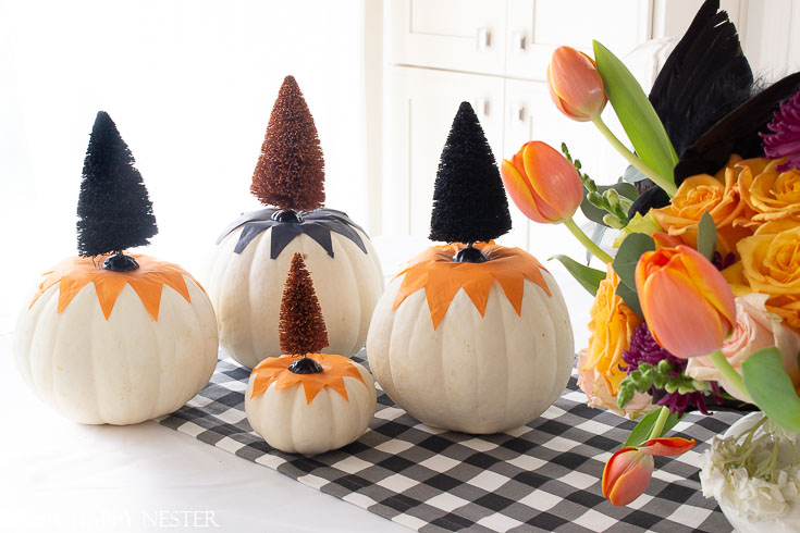 This cute tissue paper pumpkin craft is so easy. You can tack it down with glue or modge podge it to the pumpkin. Top with a cute Halloween bottle brush tree. #halloween #modgepodge #crafts #halloweencrafts #pumpkinideas