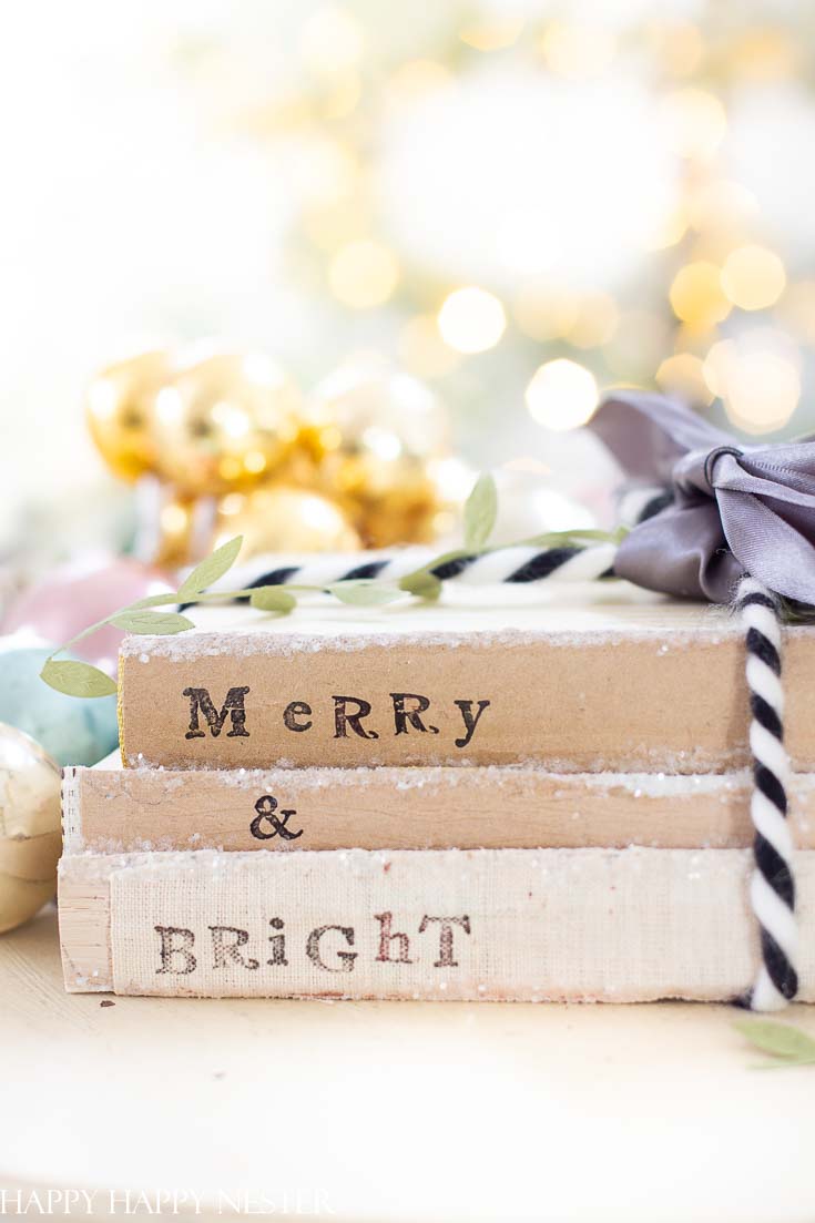 If you are looking for an easy Christmas Craft project than make sure to create these adorable stamped books. Use any old books you may have lying around the house and bring them back to life with this craft! #crafts #holidaycrafts #christmascrafts #stamping #bookstamping