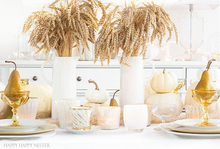 A Thanksgiving Table doesn't have to be expensive. Add natural elements to create a warm and inviting table. Wheat, pumpkins, and fruit are inexpensive and beautiful and add that perfect touch of Autumn! #wheat #thanksgivingtable #thanksgiving #tabledecor