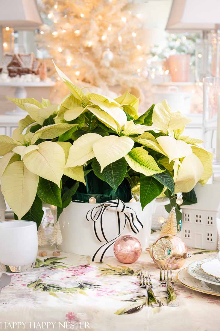 Check out this round-up of Christmas Dining Room Decorations. These styles range from winter white to vintage pink table decor. Whatever your taste, there are lots of Christmas table inspiration happening over here. #christmastable #christmasdecorating #holidaydecorating