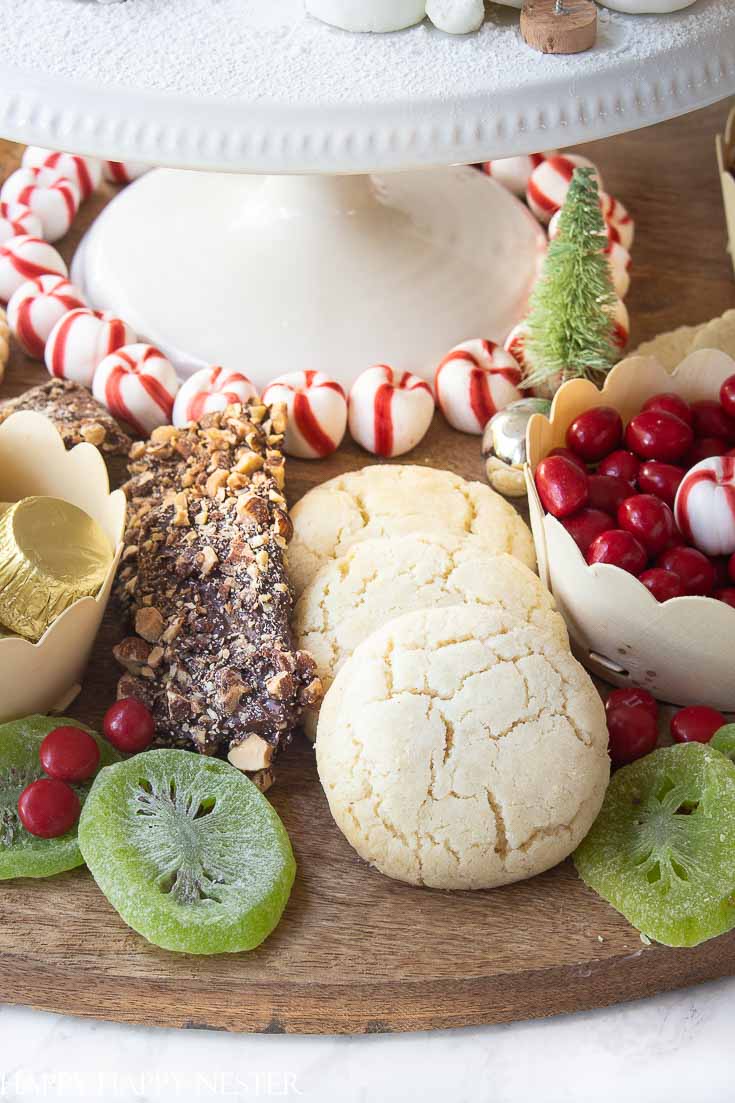 Add your favorite items to create this fun Christmas dessert board. This charcuterie includes my favorite chocolate chip, raspberry heart, and almond cookie recipes. #cookies #christmasdessert #christmascookies