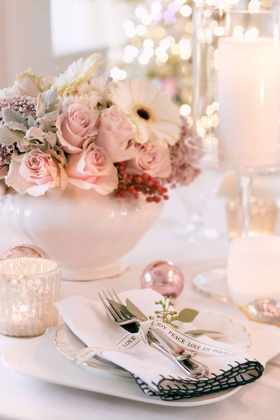 Setting a Christmas table is easy when you have a few decor elements. This holiday home night tour shows off a vintage pink romantic table. Visit this post for some Christmas inspiration! #holidaytable #christmastable 