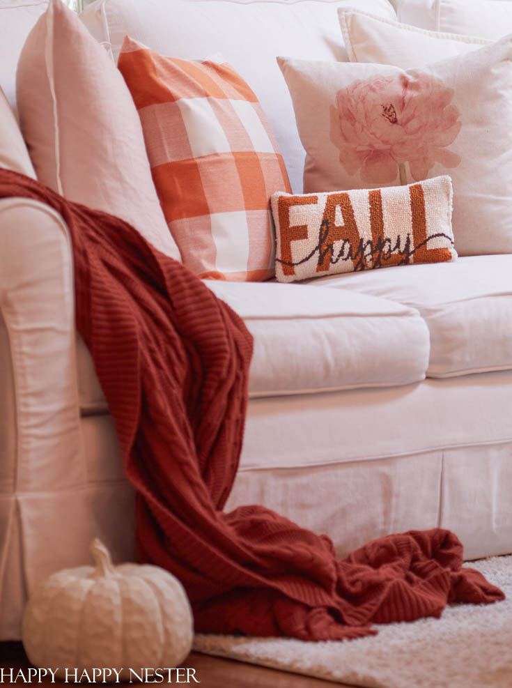 a cozy blanket, leaf pillow and fireplace for fall - Funky Junk Interiors