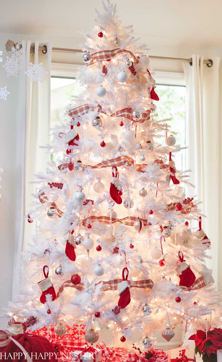 white christmas tree with silver and red decorations