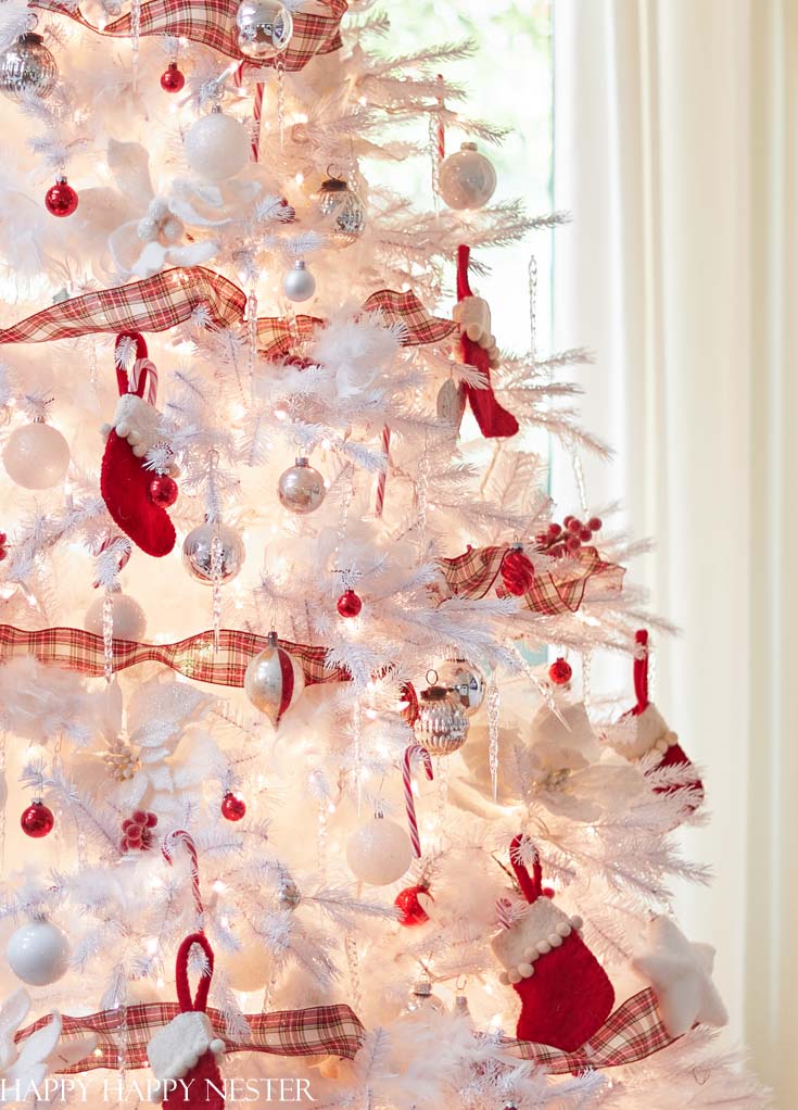 white christmas tree with silver and red decorations