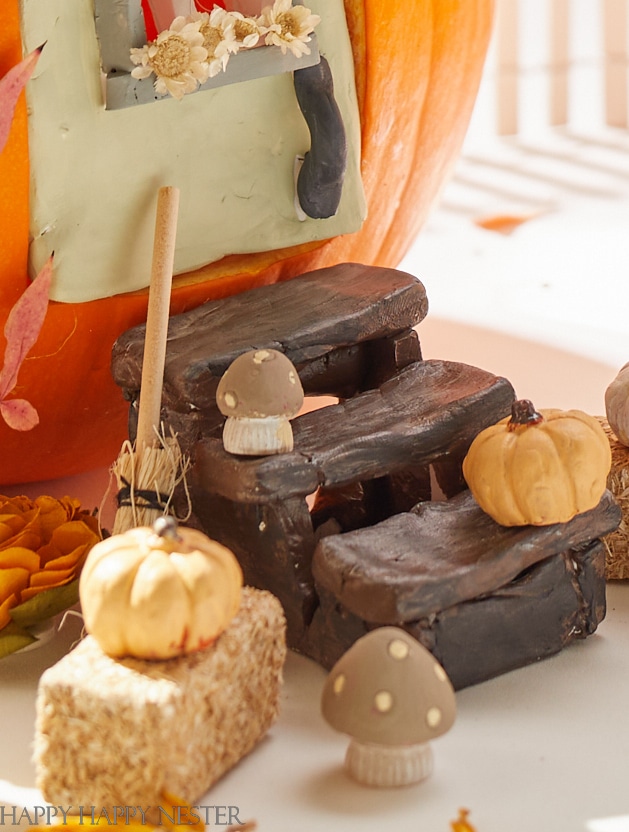 wooden steps for miniature house made out of a pumpkin