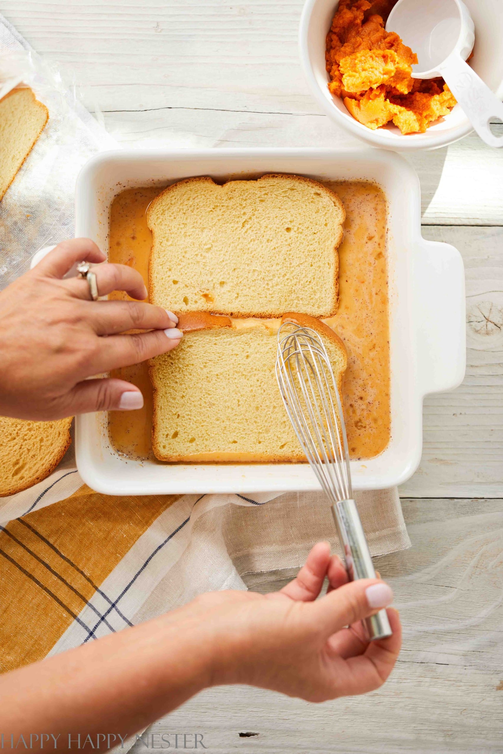 pumpkin brioche french toast soaking in a pan