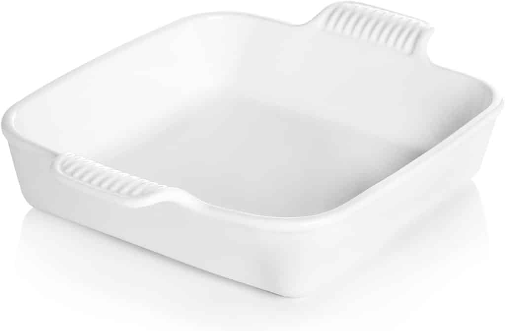 A square white ceramic baking dish with two ribbed handles on opposite sides, perfect for baking old fashioned lemon squares, shown empty against a plain white background.