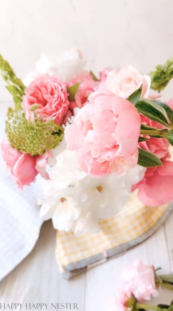 This is a close-up of pink peonies and white roses.