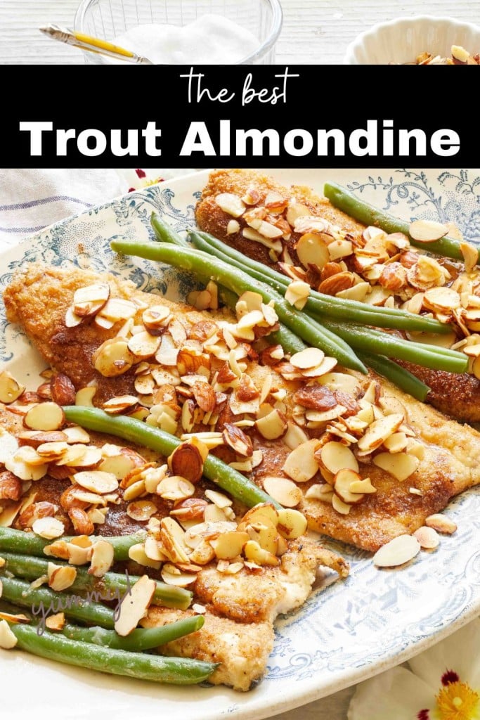 a pin image for pinterest showing the three trout topped with toasted sliced almonds all on a French platter