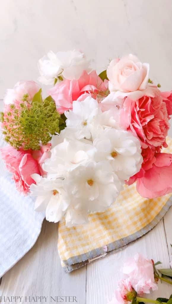 This step by step photo shows white and pink roses as well as queen anne's lace. 