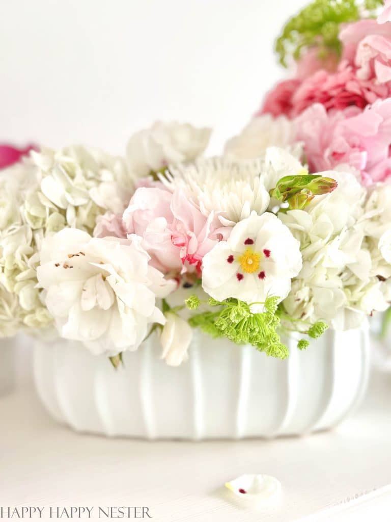 A peony arrangement in a white planter container