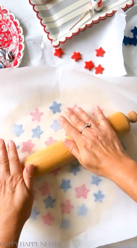 rolling the sugar cookie dough with two sheets of parchment paper